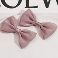 Detail of pink double-layered soft mesh hair bows with subtle shimmering texture - Deep purple