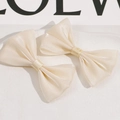 Detailed view of dual-layer soft cream mesh bow hair clips with elegant sheer texture - Beige