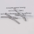Macro detail of handmade grey velvet bow tie hair clip accessories on white card - Gray