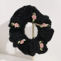 Close-up of black plush scrunchie with five handmade pink ribbon roses and green leaves - Black
