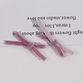 Detail of pink velvet ribbon bow hair clips with soft textured flocking on white background - Light Purple