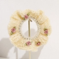 Close-up of cream knit hair tie with handmade pink ribbon roses and green leaves - Beige
