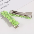 Detail view of AB crystal duckbill hair clips with iridescent green beads on white background - Fluorescent Green