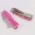 Dettaglio delle paillettes rosa lucide e della clip in metallo dei fermagli per capelli - Rosa Rosso