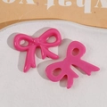 Close-up of pink glossy resin bow charms for DIY jewelry and hair accessory making - Bow / Rose Red