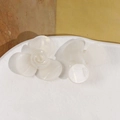 Vue détaillée de mini pinces à fleurs en acétate nacré sur une assiette en céramique - Patch à Trois Pétales / Blanc