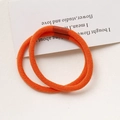 Detail view of two bright orange braided elastic hair ties with seamless brown connectors - Orange