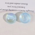 Close-up of sky blue round acrylic cabochons with glitter and iridescent shimmer - Light Blue