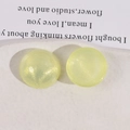 Detail of round yellow glitter acrylic charms with aurora finish on ceramic tray - Light Yellow