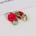 Pink ribbon rose craft with green leaf loops and a tiny ladybug detail for DIY projects - Rose Red