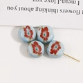 Detailed macro view of 12mm floral ceramic beads with red flowers for DIY jewelry making - Light Blue