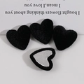 Detailed view of heart-shaped black flocked metal buttons for DIY jewelry making - Black