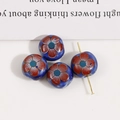 Macro shot of four 12mm blue ceramic floral beads for DIY earring and jewelry making - Dark Blue