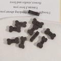 Dark brown bone-shaped wooden buttons with natural grain and two holes for DIY sewing projects - Bone Shape