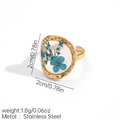 Detailed macro view of an adjustable gold stainless steel ring with blue dried flowers - Irregular Frame Blue Dried Flower (JDR256172-7)
