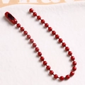 Macro detail of red painted ball chain with metal connector for DIY jewelry projects - Dark Red
