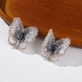 Close-up of fabric butterfly earrings with shimmering crystals and beaded details - Gray