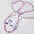 Macro detail of 8mm purple and pink crackle quartz beads for DIY jewelry making - Purple-pink Gradient