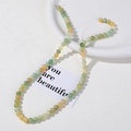 Macro detail of 8mm ice-cracked round natural stone beads for DIY jewelry making - Green Yellow Fresh Mix