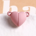 Macro-opname van de roze hartvormige magnetische sluiting met matte afwerking voor sieraden - Dieproze