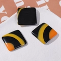 Detail of 23mm square resin accessory with irregular black, yellow and orange stripes - Square Black Yellow Orange Large