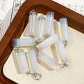 Macro shot of cylindrical opal stone charms with silver rings for DIY jewelry making - Iridescent Milky Opal Style (No. 7)