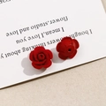 Detail of red rose earrings with premium flocking texture on elegant white card stock - Red