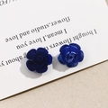 Detailed view of matte flocked and glossy blue rose charms for DIY hair accessories - Dark Blue