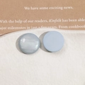 Close-up of circular blue resin charms with pearlescent and matte textures for DIY jewelry - Light Blue Round