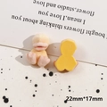 Close-up of a 22mm yellow flocked duckling charm showing both front texture and flat back side - Little Duck
