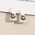 Detailed macro view of white resin ghost pendants with quirky faces for DIY jewelry making - White (B68-5-4)
