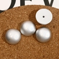 Close-up of polished silver convex oval beads for DIY jewelry and phone case crafts - Round