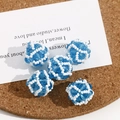 Close-up of handmade woven blue crystal beads with intricate spherical mesh structure - 1 Piece / Blue