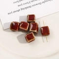 Macro detail of cube-shaped ceramic beads with reddish-brown glaze and jewelry puncture hole - 12mm (1 Piece) / Dark Red