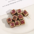 Macro detail of handmade square ceramic beads with floral glaze for DIY jewelry making - 12mm (1 Piece) / Pink