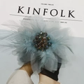 Detail of a handmade floral hair clip with light blue mesh, soft feathers and crystal beads - Blue