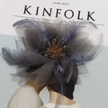 Close-up of handmade tulle flower hairpiece with soft feathers and crystal beads - Gray