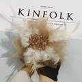 Detail of handmade mesh flower fascinator with soft white feathers and crystal center - Light Coffee