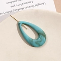 Teal marble ink acrylic drop pendant with gold pin detail on a ceramic tray - Teal