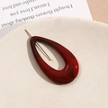 Detail of dark red marble ink-wash resin teardrop pendant with gold metal pin - Red