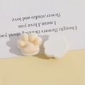 Macro view of cute plush cat paw resin charms for DIY jewelry and accessories - Yellow