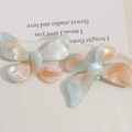 Detailed macro view of butterfly hair clips with marble texture acetate on white tray - Blue Green Orange Gradient Butterfly (Style 2)