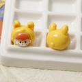 Macro detail of cute resin rabbit girl DIY charms showing front and back views - Yellow Rabbit Baby