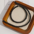 Macro shot of natural porous black volcanic lava stone beads for DIY jewelry making - 5mm Strand (Approx. 87 Beads)