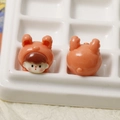 Macro detail of cartoon bunny girl resin charms for DIY craft and phone case decor - Orange Rabbit Baby