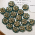 Macro detail of blue rose glass beads with gold-rimmed petals for DIY jewelry making - 1 Piece / Dark Green