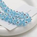 Close-up of light blue glass beads with delicate floral patterns for DIY jewelry making - 1 Piece/Pack (10x14mm) / Sky Blue