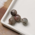 Close-up of 12mm colorful spotted natural stone beads with silver metal connectors - Light Purple