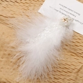 Ethereal white feather hair accessory with pearl flower beads on brown paper - White