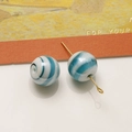 Dettaglio macro di perle in vetro lampwork da 12mm blu e bianche per gioielli fai-da-te - Verde petrolio